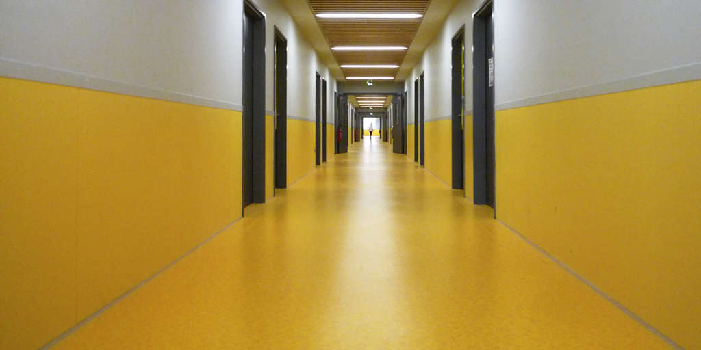 yellow coloured wall protector in hallway