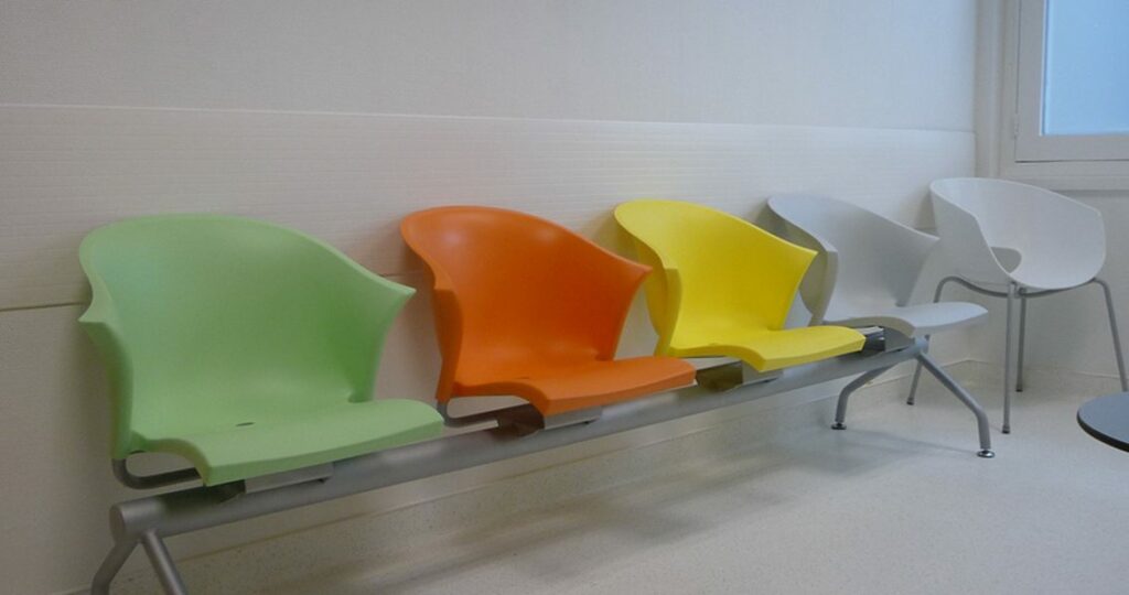 Colourful chairs next to wall protection in office